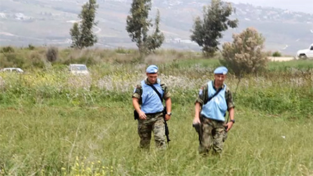 dos cascos azules se dirigen hacia el campesino